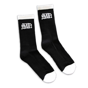 Black sad sock with white top band and toe band